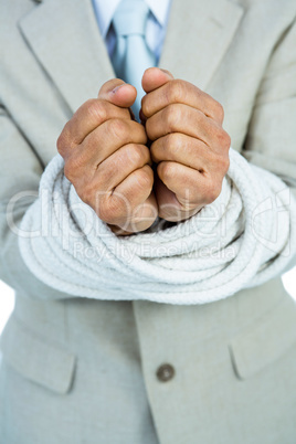 Businessman tied up in rope