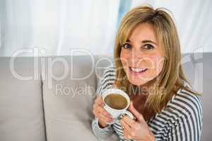 Smiling woman drinking some tea