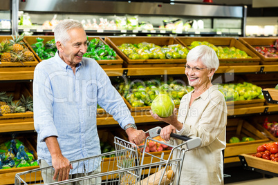 Senior couple picking out fruit