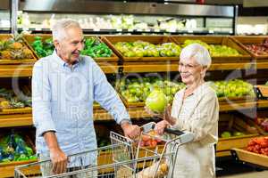 Senior couple picking out fruit