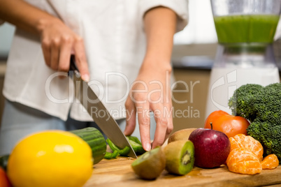 Close up of woman slicing vegetables for smoothie