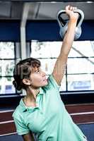 Portrait of woman holding kettlebell