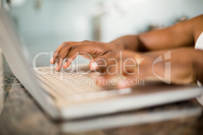 Masculine hands typing on laptop keyboard