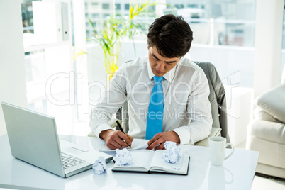Busy asian businessman writing