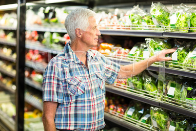 Senior man picking out salad