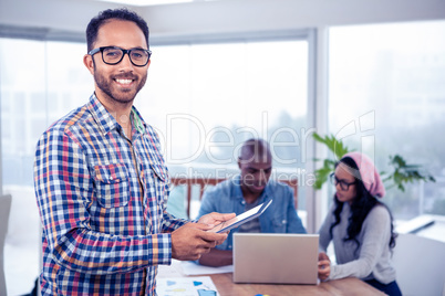 Portrait of happy businesswomen using digital tablet