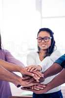 Businesswoman stacking hands with team