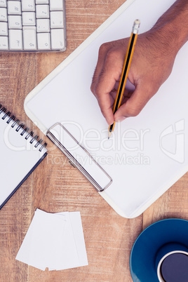 Directly above shot of businessman writing on notebook
