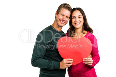 Portrait of smiling couple holding heart shape