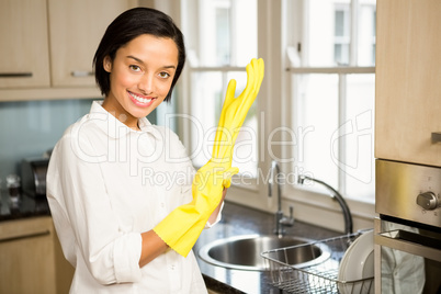 Smiling brunette wearing yellow gloves