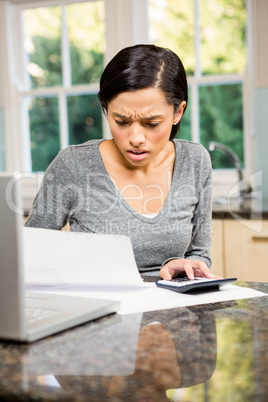 Worried brunette counting bills