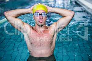 Fit swimmer holding his head with his hands