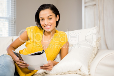 Smiling brunette reading document