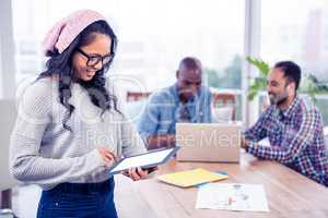 Cheerful young businesswoman using digital tablet