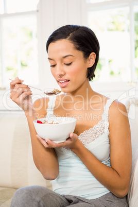 Attractive brunette eating cereals