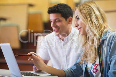 Smiling college students using laptop Smiling college students using laptop