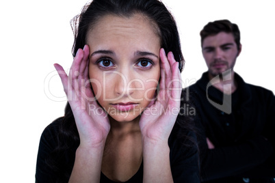 Sad woman looking at camera with sad man