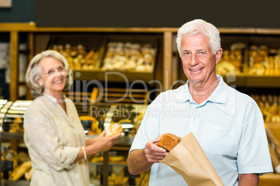 Senior couple buying bread