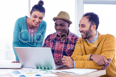 Happy business people working on laptop