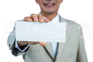 Smiling businessman showing blank paper