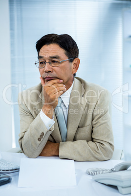 Undecided businessman at his computer