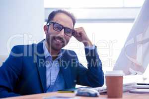 Portrait of happy business leaning on desk