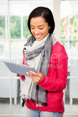 Smiling brunette using tablet