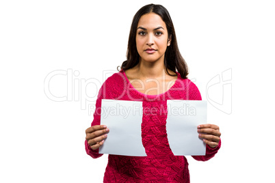 Portrait of woman holding torn documents