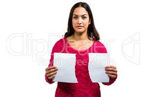 Portrait of woman holding torn documents