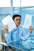 Busy businessman showing papers