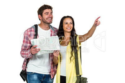 Happy couple holding map and pointing somewhere