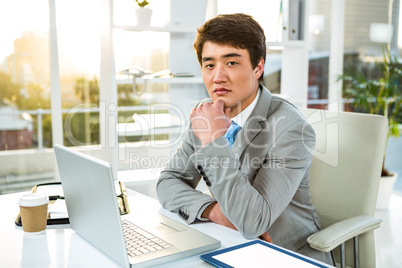 Serious Asian man sitting