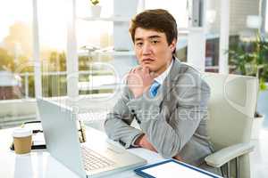 Serious Asian man sitting