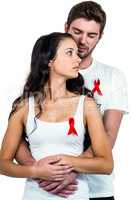 Couple hugging with red ribbon