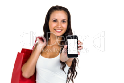 Portrait of smiling woman showing smartphone