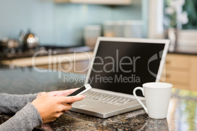 Close up of woman using smartphone and laptop Close up of woman using smartphone and laptop