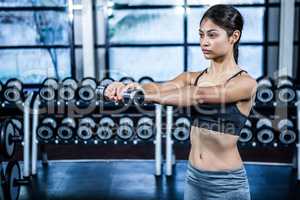 Fit woman exercising with dumbbells
