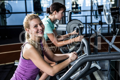 Fit women doing exercise bike