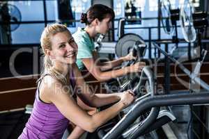 Fit women doing exercise bike