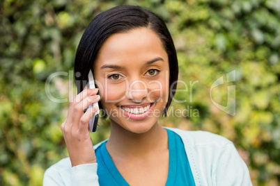 Smiling brunette on a phone call