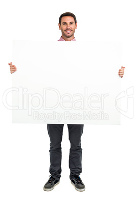 Smiling man holding white sheet