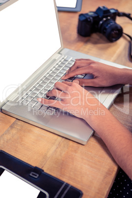Businesswoman typing on laptop keyboard