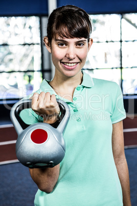 Portrait of woman holding kettlebell