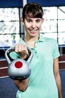 Portrait of woman holding kettlebell