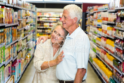 Happy senior couple at the supermarket