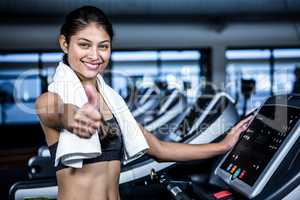 Smiling fit woman showing thumbs up
