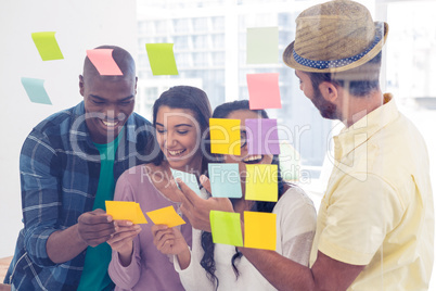 Cheerful business team holding adhesive notes