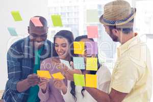 Cheerful business team holding adhesive notes