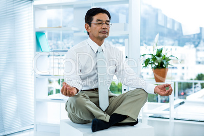 Concentrated asian businessman relaxing