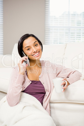 Smiling brunette on a phone call